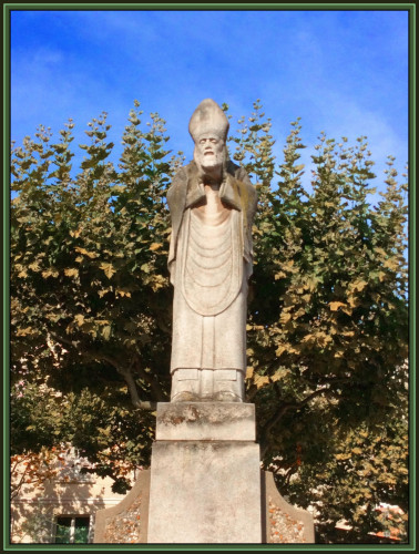 St. Denis holding his head. A sculpture in a Montmartre park.